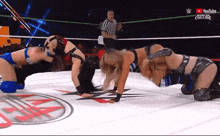 three women are wrestling in a ring with a referee in the background and a youtube logo on the bottom right