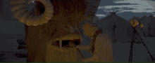 a statue of a monster with horns is standing in front of tents