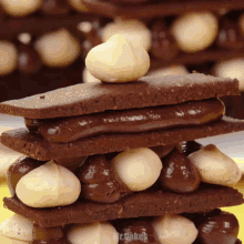 a close up of a stack of chocolate sandwiches with the words mr.cakes on the bottom right