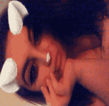 a close up of a woman 's face with horns on it