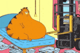 garfield is laying on a bed with a forklift behind him