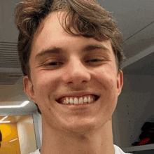 a young man is smiling with his teeth showing