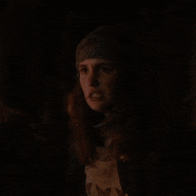 two men are looking at each other in the dark