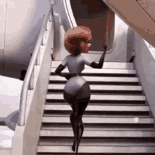 a woman is walking up a set of stairs .