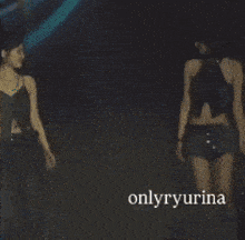 a group of women holding hands on a stage with onlyryurina written on the bottom right