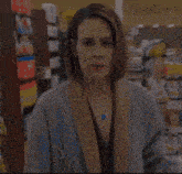 a woman in a store with a sign that says " fields "