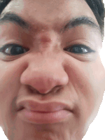a close up of a person 's face making a silly face