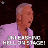 a man in a purple suit is saying unleashing hell on stage !