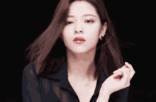 a woman wearing a black shirt and red lipstick