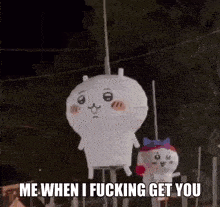 a couple of stuffed animals are hanging from a pole .