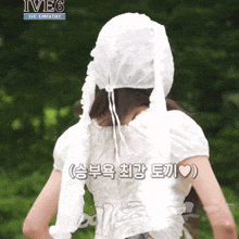 a woman wearing a white top and a white hat with ive6 written on the top