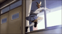 a girl is climbing out of a window in a school .