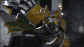 a close up of a robot 's arm with a green and gold shield on it