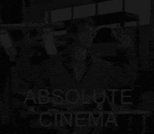 a black and white photo of a man with the words " absolute cinema " below him