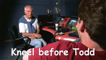 a man sits in front of a microphone with the words " kneel before todd " above him