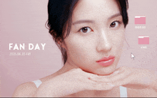 a woman 's face is displayed on a pink background with fan day written on it