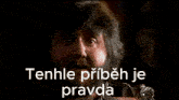 a man with a beard is smiling and holding a watch with the words tenhle pribeh je pravda below him