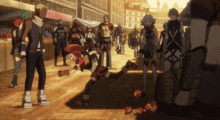 a group of people are standing around a person laying on the ground in a crowded area