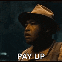 a man in overalls is holding out his hand with the words pay up written on it
