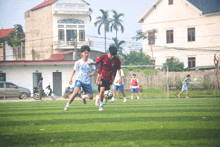a group of young men are playing soccer on a field and one of them has the number 21 on his jersey
