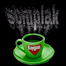 a green baygon cup on a saucer with smoke coming out of it