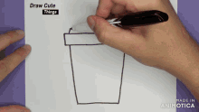 a person is drawing a cup of coffee on a piece of paper with the words draw cute things above it