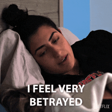 a woman laying in bed with the words i feel very betrayed