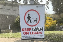 a sign that says keep karen on leads is outside
