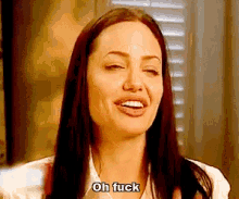 a woman with long hair is making a funny face and saying oh fuck