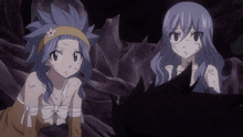 a girl with a flower on her head is standing next to another girl with blue hair