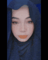 a close up of a woman wearing a blue scarf