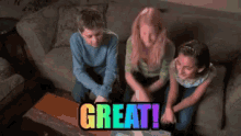 a group of children are sitting on a couch with the word great written on a table in front of them