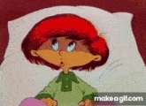 a cartoon character with red hair and freckles is laying in a bed .