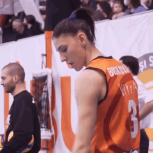 a female basketball player wearing a jersey with the number 3 on it