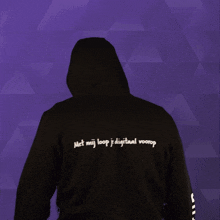 a man wearing a black hoodie that says voxtut on it