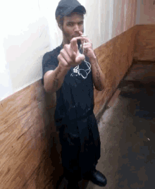 a man wearing a black shirt that says ' i love you ' on it is standing in a hallway