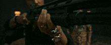 a close up of a person holding a gun .