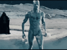 a naked man standing in a snowy field