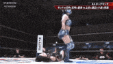 a wrestling match is being shown on a screen that says stardom