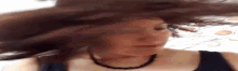 a woman with long hair is making a funny face .