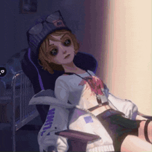 a girl is sitting in a chair with a hat that says ' i love you ' on it