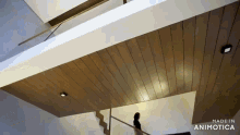 a staircase with a wooden ceiling and the words made in animotica