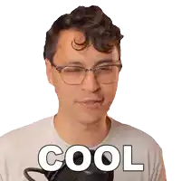 a man wearing glasses and a white shirt with the word cool written on it