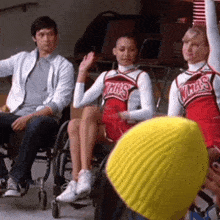 two cheerleaders wearing red uniforms with the word chris on them