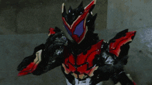 a black and red superhero with a purple mask