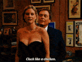 a woman in a strapless dress says cluck like a chicken in front of a man in a suit