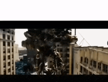 a transformer is flying over a city in front of a building .