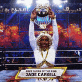 a woman in a wrestling ring is holding a trophy that says 2025 queen of the ring jade cargill