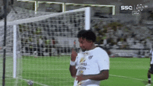 a soccer player in a white shirt with the word ssc on the bottom right