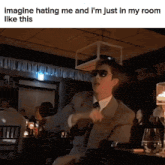 a man in a suit and tie is sitting at a table in a room .